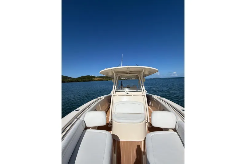  Yacht Photos Pics 2018 Grady-White Canyon 336 boat on calm water under clear blue sky.