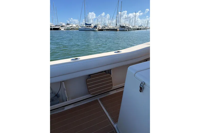  Yacht Photos Pics 2018 Grady-White Canyon 336 boat interior with marina view and clear blue sky.