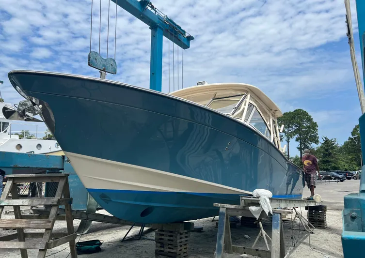 Daddy's Broke Lll Yacht Photos Pics 2020 Grady-White Canyon 306 boat in dry dock, blue hull, under maintenance.