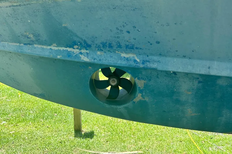 Daddy's Broke Lll Yacht Photos Pics 2020 Grady-White Canyon 306 boat hull with visible thruster on grass.