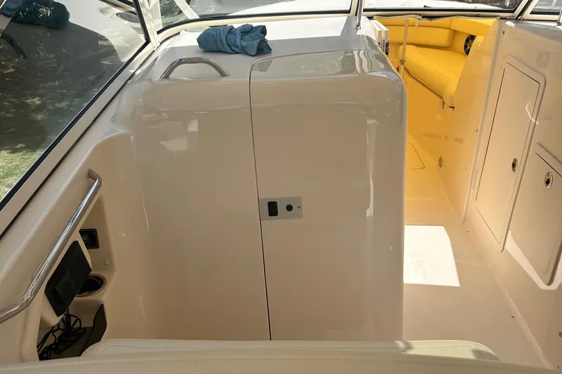 Daddy's Broke Lll Yacht Photos Pics 2020 Grady-White Canyon 306 boat interior with yellow seating and storage compartments.
