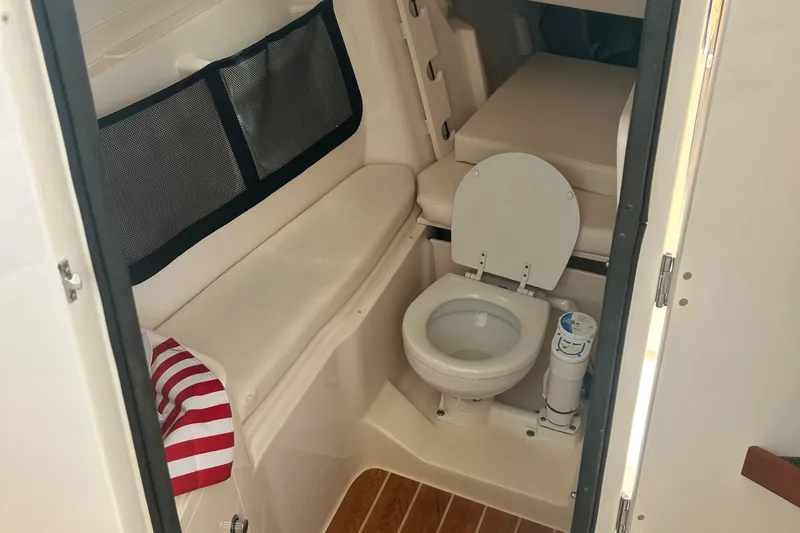 Daddy's Broke Lll Yacht Photos Pics 2020 Grady-White Canyon 306 boat interior with toilet and seating area.