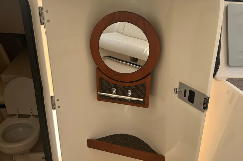 Daddy's Broke Lll Yacht Photos Pics 2020 Grady-White Canyon 306 interior with mirror and bathroom view.