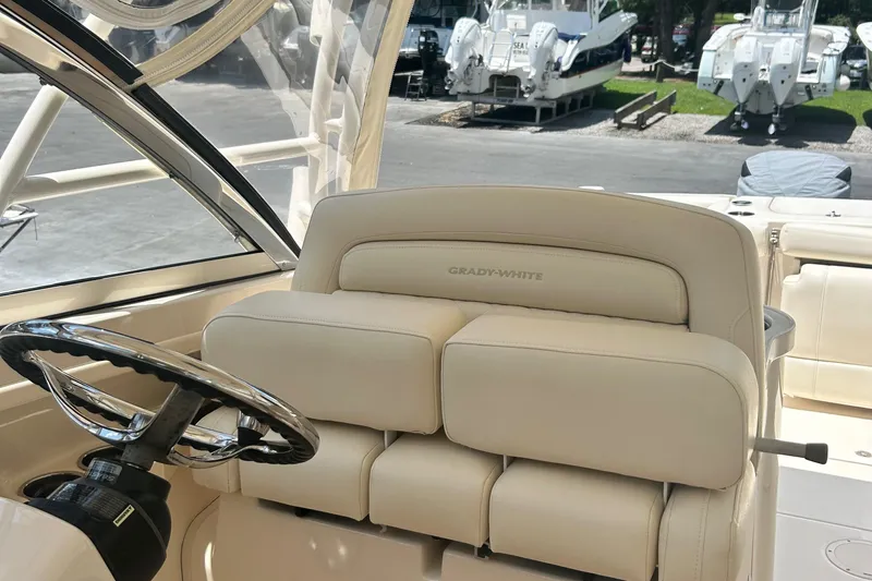 Daddy's Broke Lll Yacht Photos Pics 2020 Grady-White Canyon 306 boat interior with steering wheel and seating.