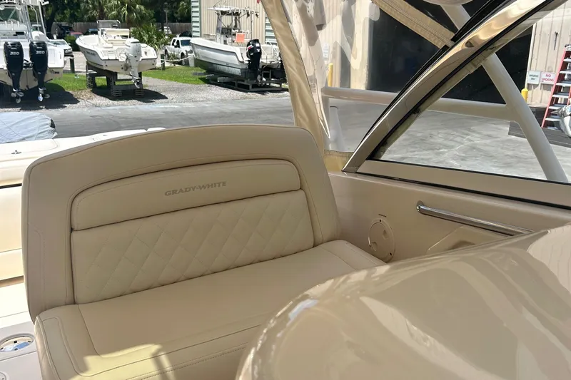 Daddy's Broke Lll Yacht Photos Pics 2020 Grady-White Canyon 306 boat interior with beige seating and visible marina background.
