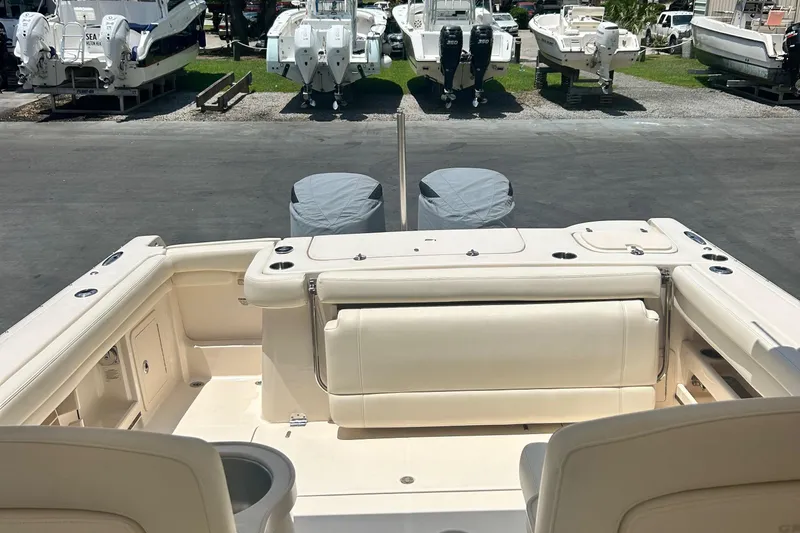 Daddy's Broke Lll Yacht Photos Pics 2020 Grady-White Canyon 306 boat interior with seating and covered engines.