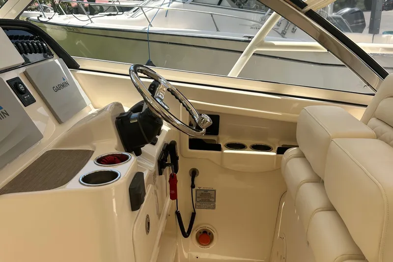 Daddy's Broke Lll Yacht Photos Pics Interior of 2020 Grady-White Canyon 306 boat with steering wheel and Garmin displays.