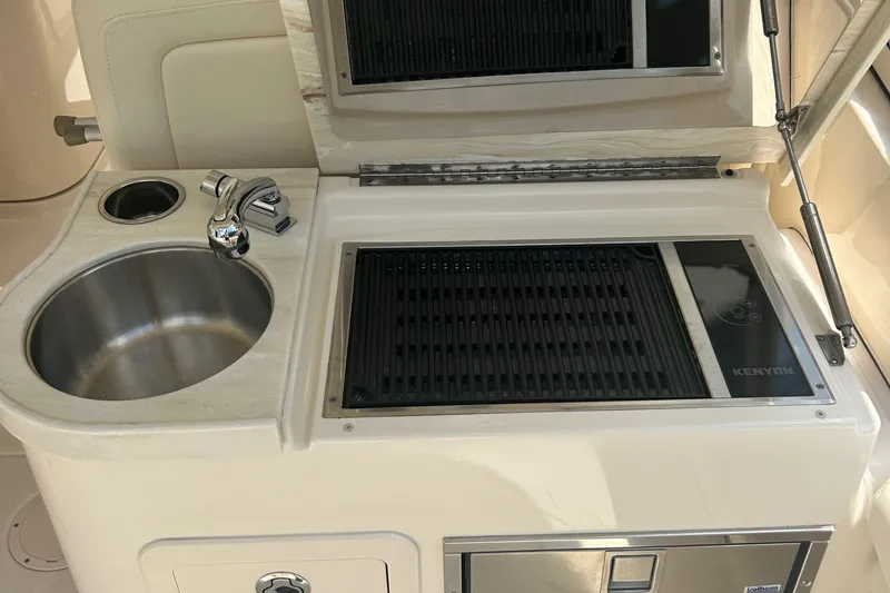 Daddy's Broke Lll Yacht Photos Pics Grady-White Canyon 306 boat kitchen with sink and Kenyon grill, 2020 model.