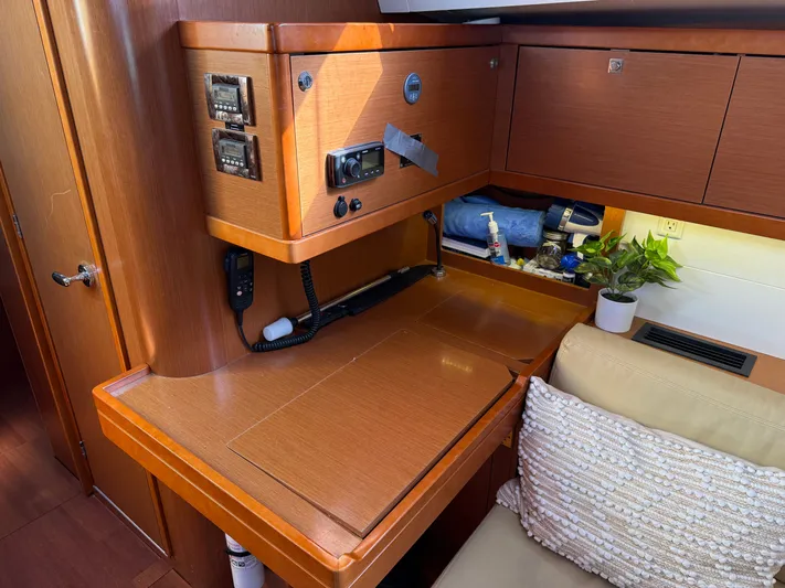 Overkill Yacht Photos Pics Interior of 2016 Beneteau Oceanis 48 with wooden furnishings and plants.