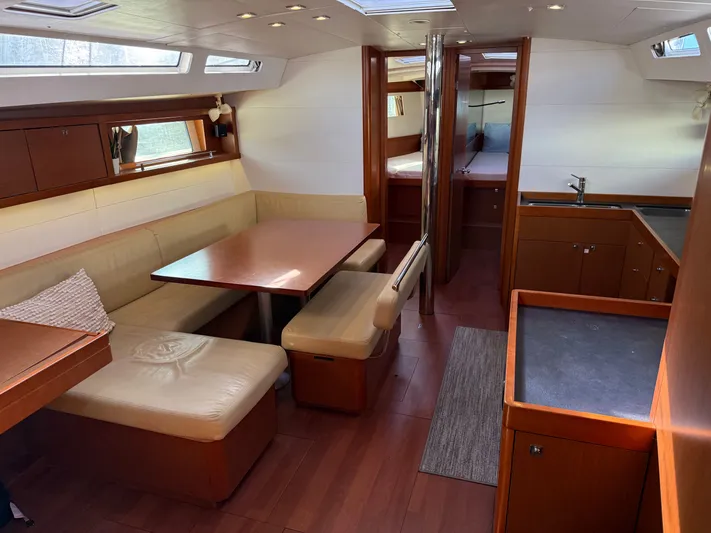 Overkill Yacht Photos Pics Interior of a 2016 Beneteau Oceanis 48 yacht, featuring dining area and kitchen.