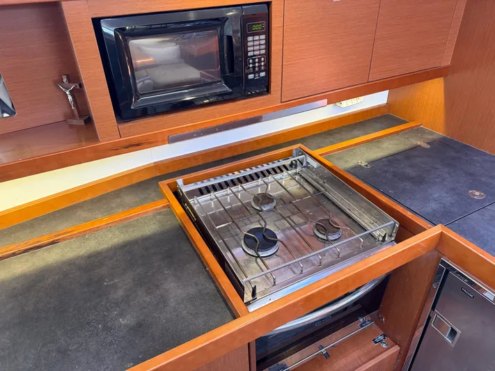 Overkill Yacht Photos Pics Beneteau Oceanis 48 yacht kitchen with stove and microwave.