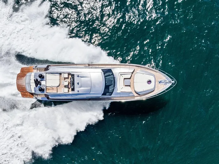 Phoenix Rising Yacht Photos Pics Aerial view of 2017 Pershing 82 yacht cruising on open water.