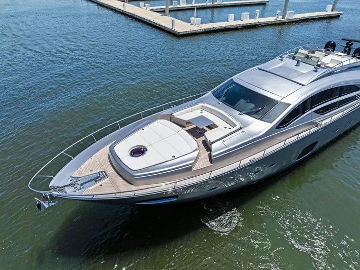 Phoenix Rising Yacht Photos Pics Luxurious 2017 Pershing 82 yacht cruising in calm waters near a marina.