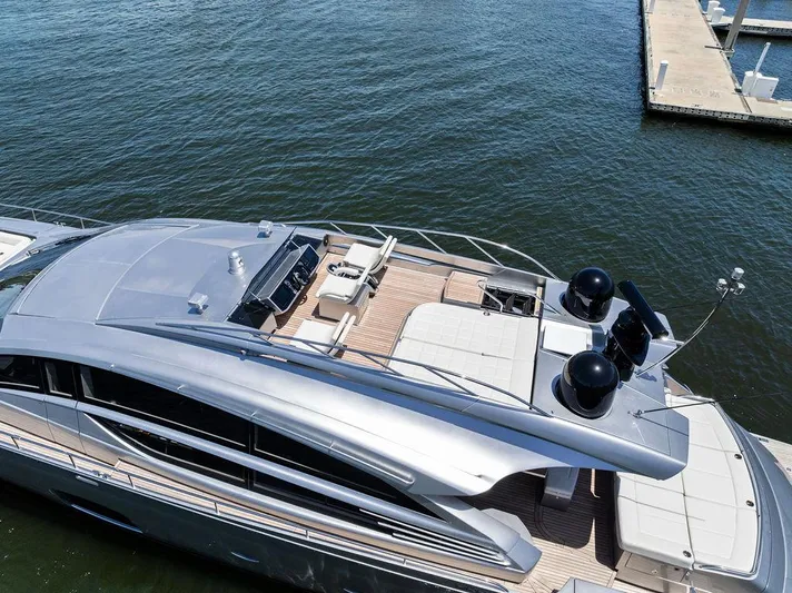 Phoenix Rising Yacht Photos Pics Luxurious 2017 Pershing 82 yacht docked, showcasing sleek design and spacious deck.