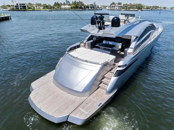 Phoenix Rising Yacht Photos Pics Luxury 2017 Pershing 82 yacht cruising on a sunny day, showcasing sleek design and spacious deck.