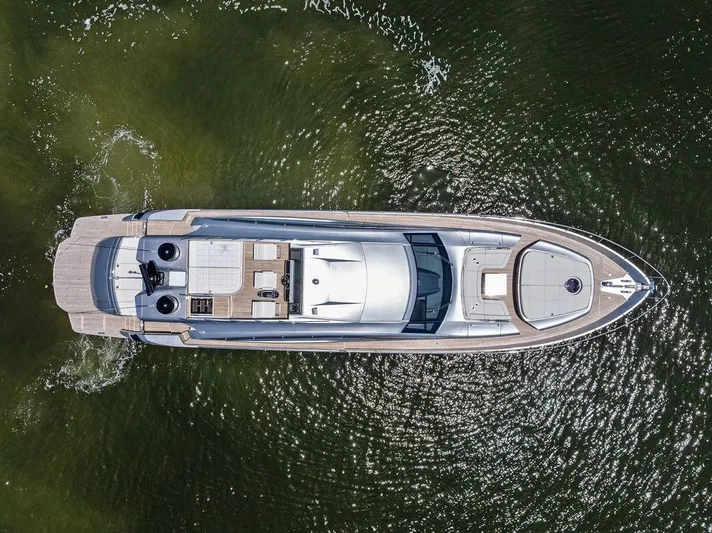 Phoenix Rising Yacht Photos Pics Aerial view of 2017 Pershing 82 yacht on calm water.