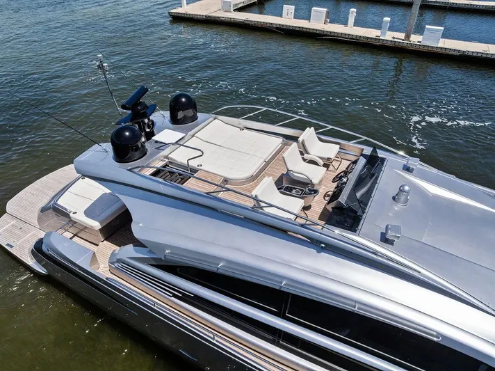 Phoenix Rising Yacht Photos Pics Luxurious 2017 Pershing 82 yacht docked, featuring sleek design and spacious upper deck.