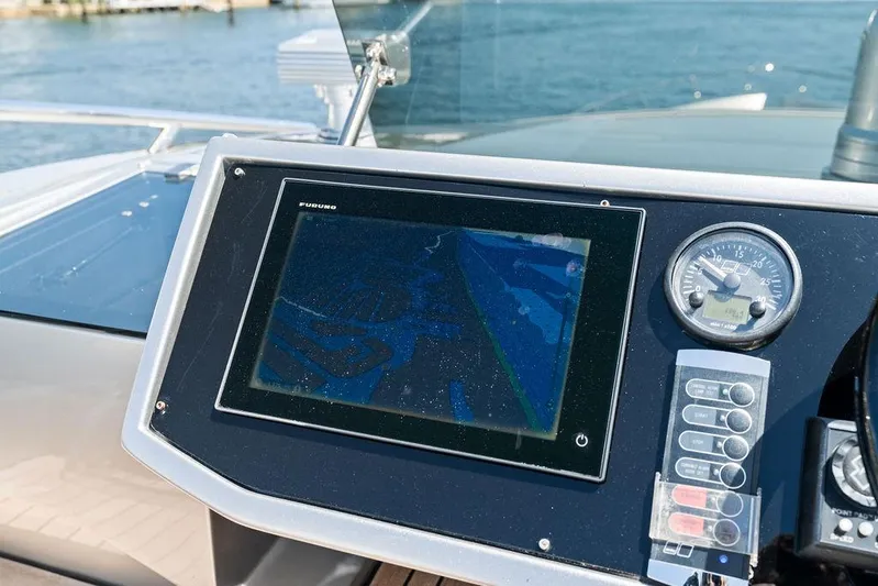 Phoenix Rising Yacht Photos Pics Control panel of a 2017 Pershing 82 yacht with navigation display and gauges.