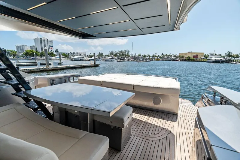 Phoenix Rising Yacht Photos Pics Luxurious 2017 Pershing 82 yacht deck with seating, overlooking marina and waterfront views.