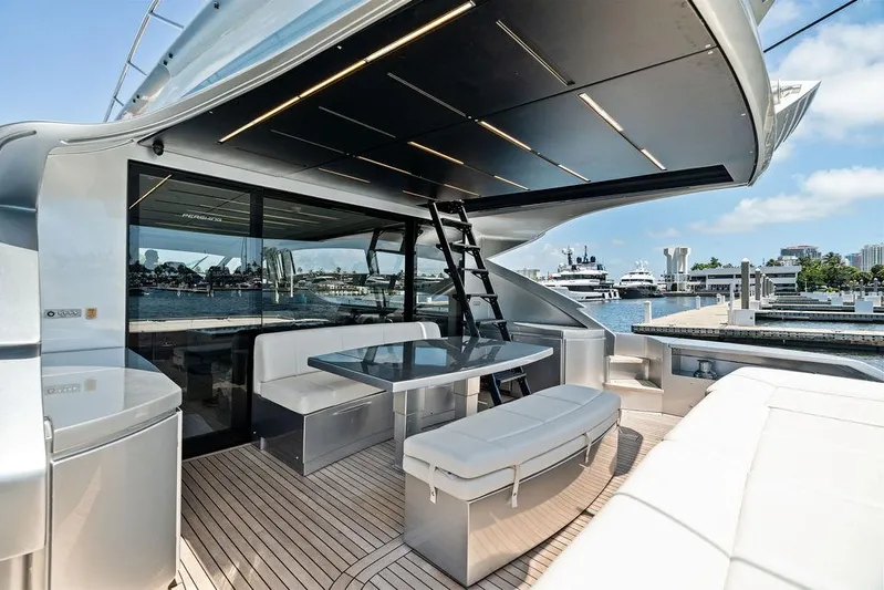 Phoenix Rising Yacht Photos Pics Luxurious 2017 Pershing 82 yacht deck with modern seating and waterfront view.