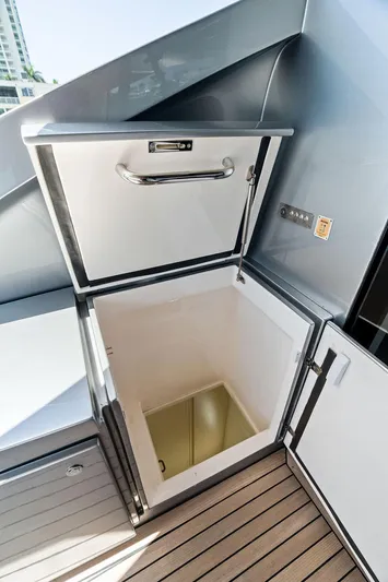 Phoenix Rising Yacht Photos Pics Open storage compartment on 2017 Pershing 82 yacht deck, featuring sleek design and modern finish.