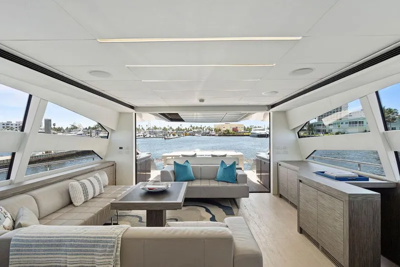 Phoenix Rising Yacht Photos Pics Luxurious interior of 2017 Pershing 82 yacht with modern seating and waterfront view.