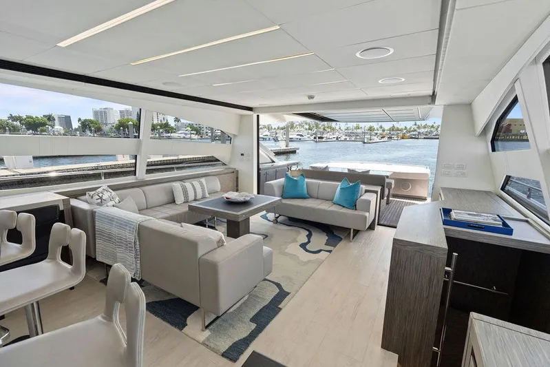 Phoenix Rising Yacht Photos Pics Luxurious interior of 2017 Pershing 82 yacht with modern seating and waterfront view.