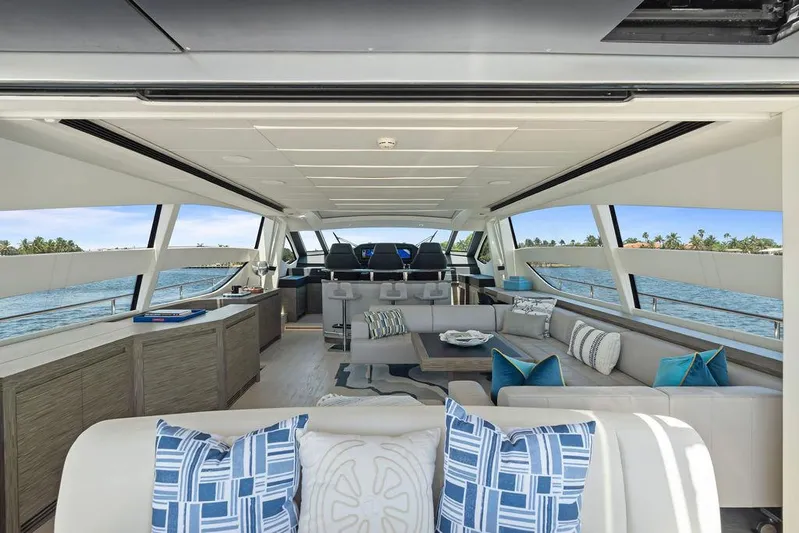 Phoenix Rising Yacht Photos Pics Luxurious interior of 2017 Pershing 82 yacht with elegant seating and panoramic windows.