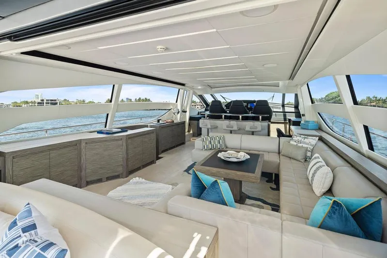 Phoenix Rising Yacht Photos Pics Luxurious interior of 2017 Pershing 82 yacht with modern seating and panoramic windows.