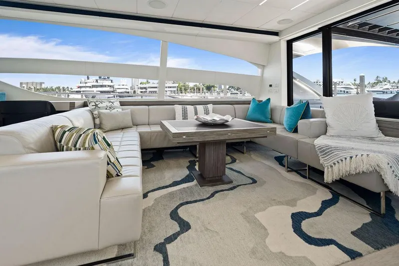 Phoenix Rising Yacht Photos Pics Luxurious interior of 2017 Pershing 82 yacht with elegant seating and modern decor.