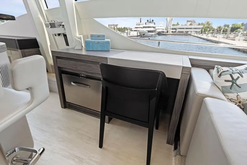 Phoenix Rising Yacht Photos Pics Luxurious interior of a 2017 Pershing 82 yacht with modern furnishings and waterfront view.