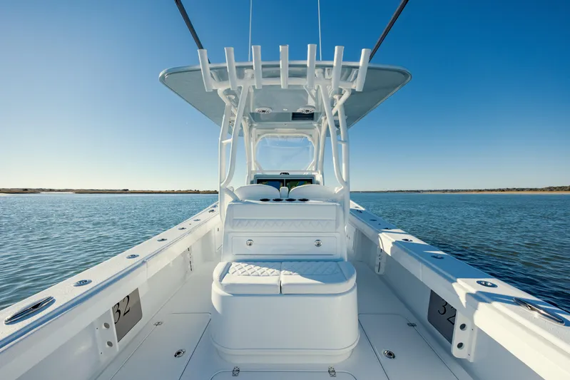  Yacht Photos Pics 2025 Yellowfin 32 boat on calm water, clear blue sky.