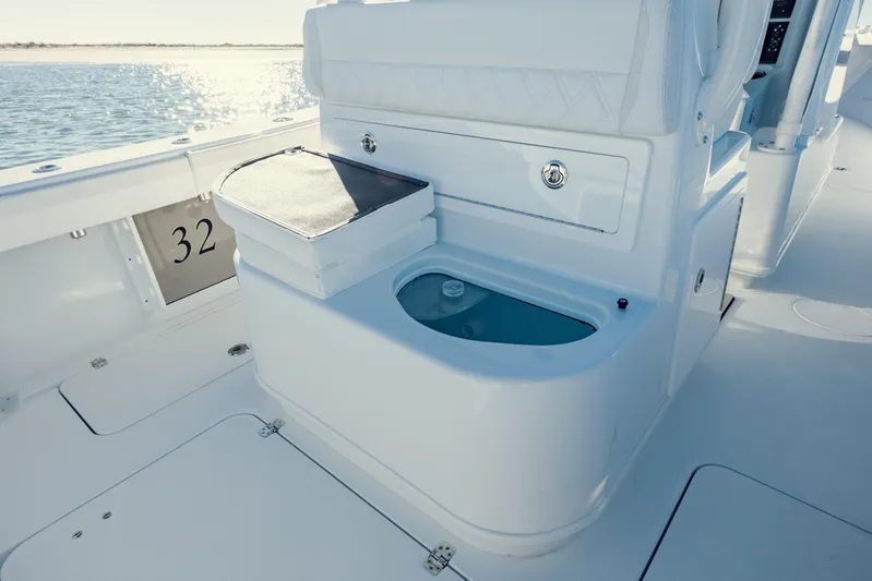  Yacht Photos Pics 2025 Yellowfin 32 boat interior with seating and storage, overlooking calm waters.