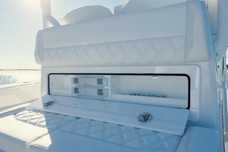  Yacht Photos Pics 2025 Yellowfin 32 boat interior with storage compartment, white upholstery, and ocean view.