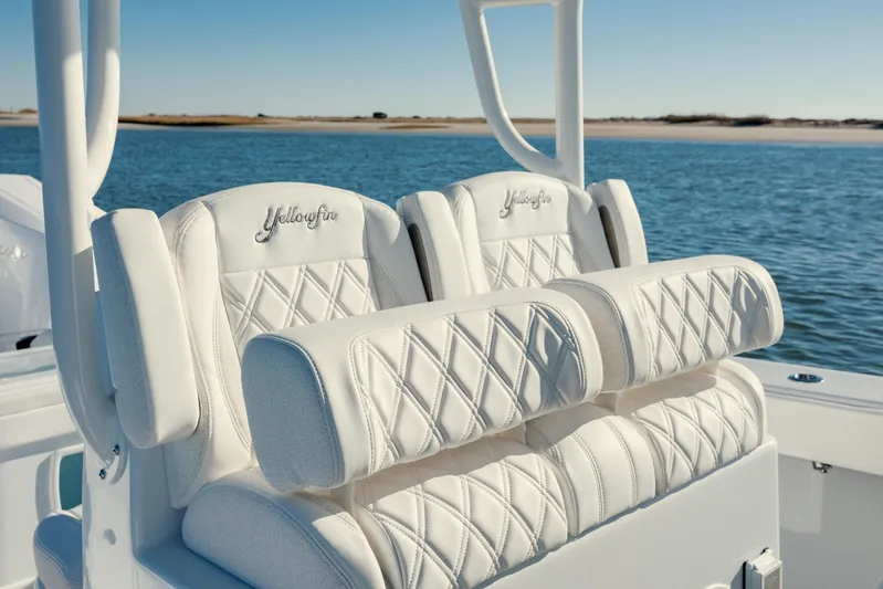  Yacht Photos Pics Luxurious seating on 2025 Yellowfin 32 boat with diamond-stitched upholstery, ocean backdrop.