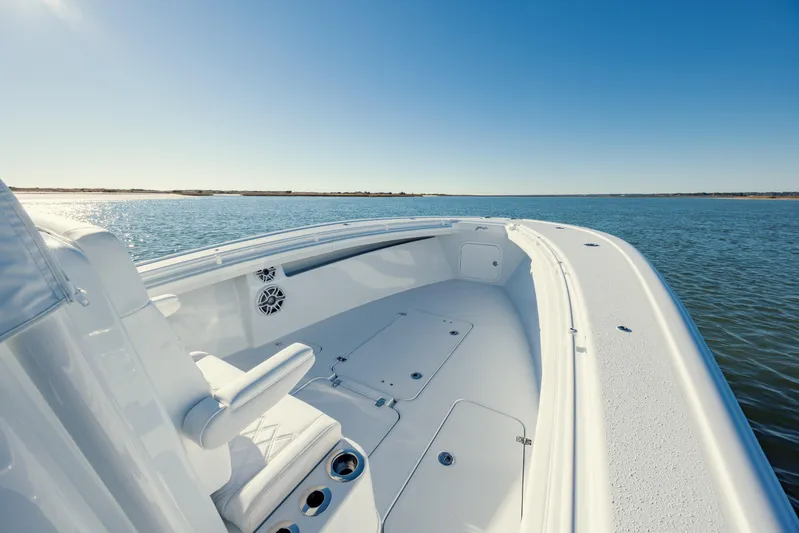  Yacht Photos Pics 2025 Yellowfin 32 boat on calm water under clear blue sky.