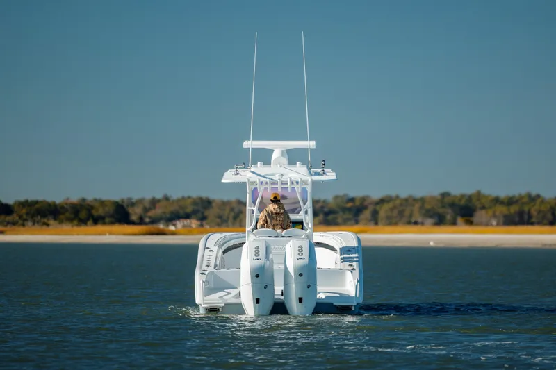  Yacht Photos Pics 2025 Yellowfin 32 boat on calm water with dual engines.