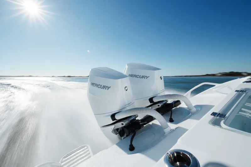  Yacht Photos Pics 2025 Yellowfin 32 boat with dual Mercury engines speeding on open water.