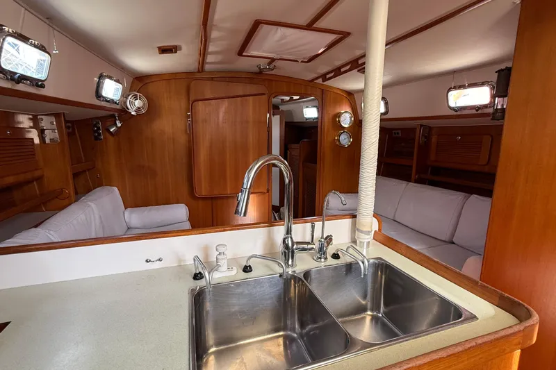 Via Yacht Photos Pics 2004 Caliber 40LRC yacht interior with wooden finish and dual sink kitchen area.
