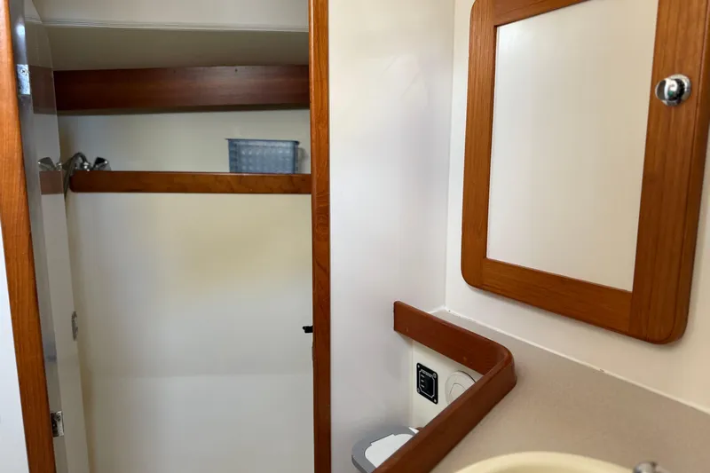 Via Yacht Photos Pics 2004 Caliber 40LRC yacht interior with wooden cabinetry and mirror.