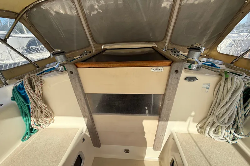 Via Yacht Photos Pics 2004 Caliber 40LRC sailboat cockpit with ropes and winches, under a protective canopy.