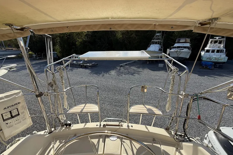 Via Yacht Photos Pics 2004 Caliber 40LRC sailboat deck with lifelines and docked boats in background.