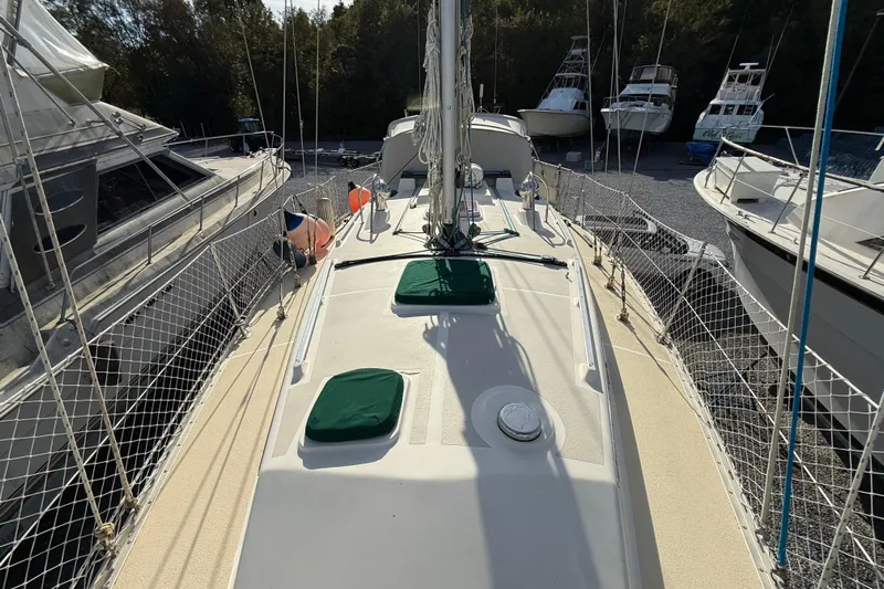 Via Yacht Photos Pics 2004 Caliber 40LRC sailboat deck with green covers, docked among other boats.