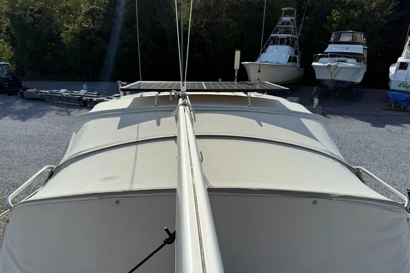 Via Yacht Photos Pics 2004 Caliber 40LRC sailboat deck view with solar panels, docked among other boats.