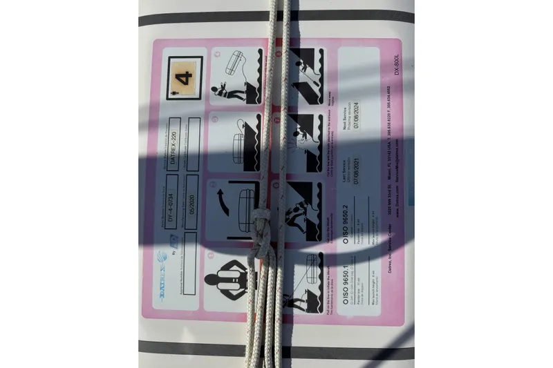 Via Yacht Photos Pics Instruction label on a 2004 Caliber 40LRC boat, featuring safety guidelines and diagrams.