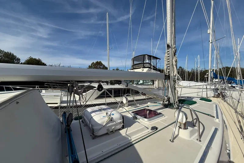 Via Yacht Photos Pics 2004 Caliber 40LRC sailboat deck with rigging and lifeboat under clear sky.