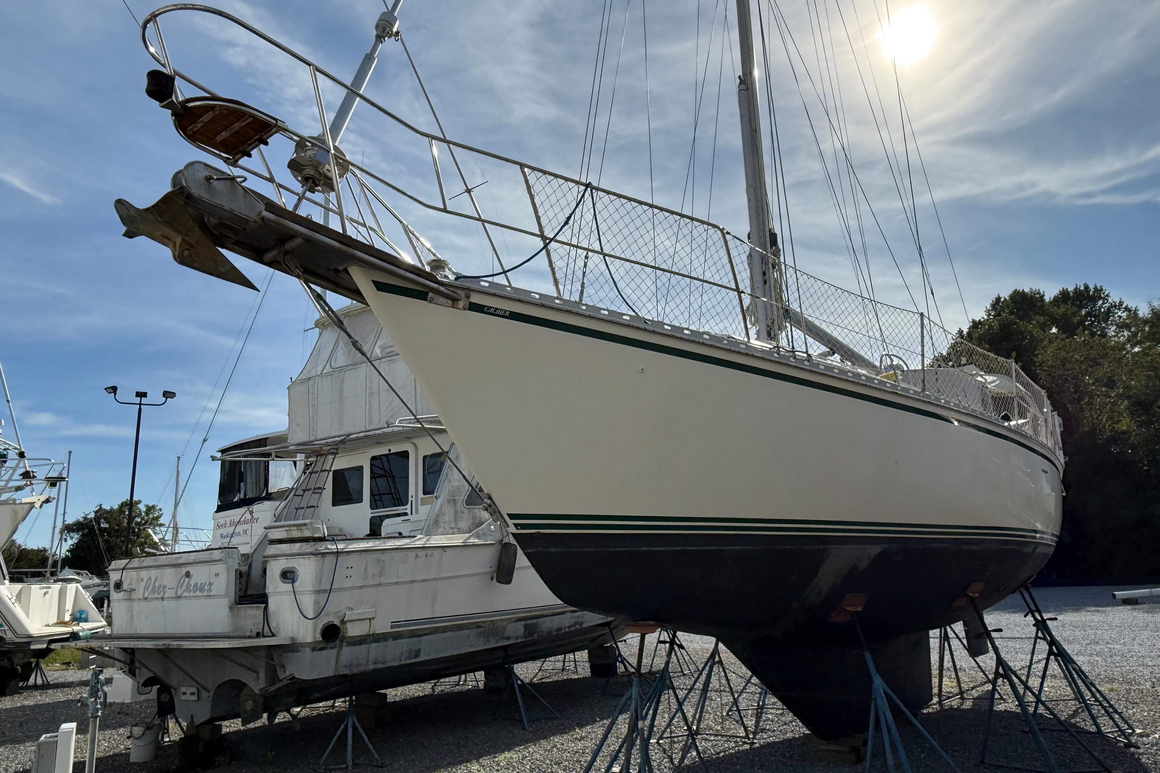 2004 Caliber 40LRC sailboat on stands, sunny day, marina background.