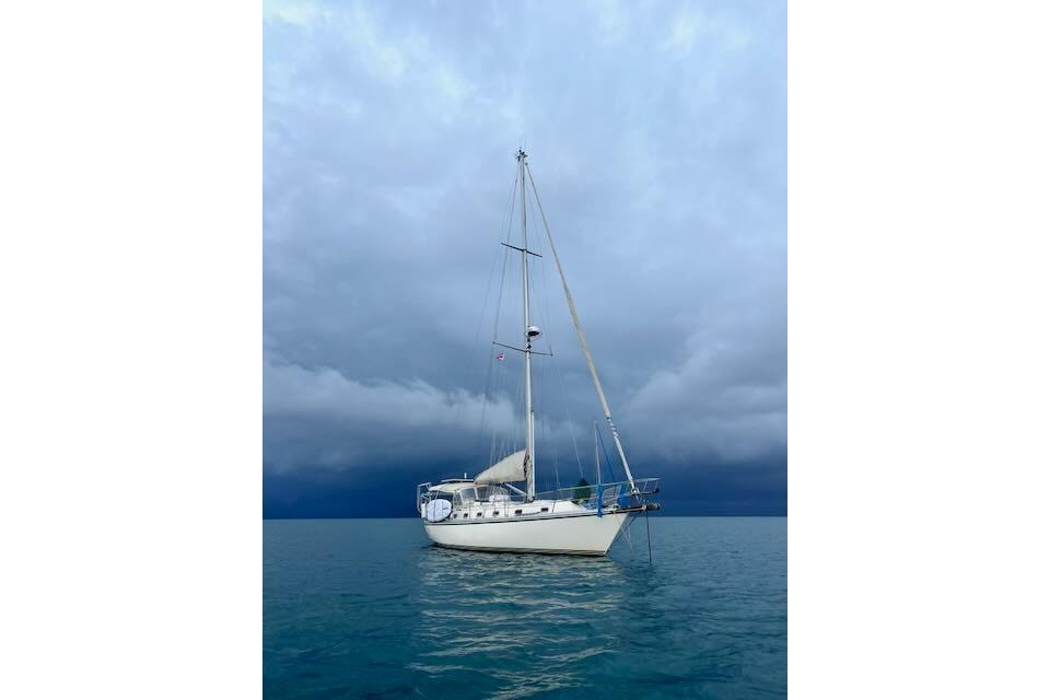Sailboat Caliber 40LRC 2004 on calm water under cloudy sky.