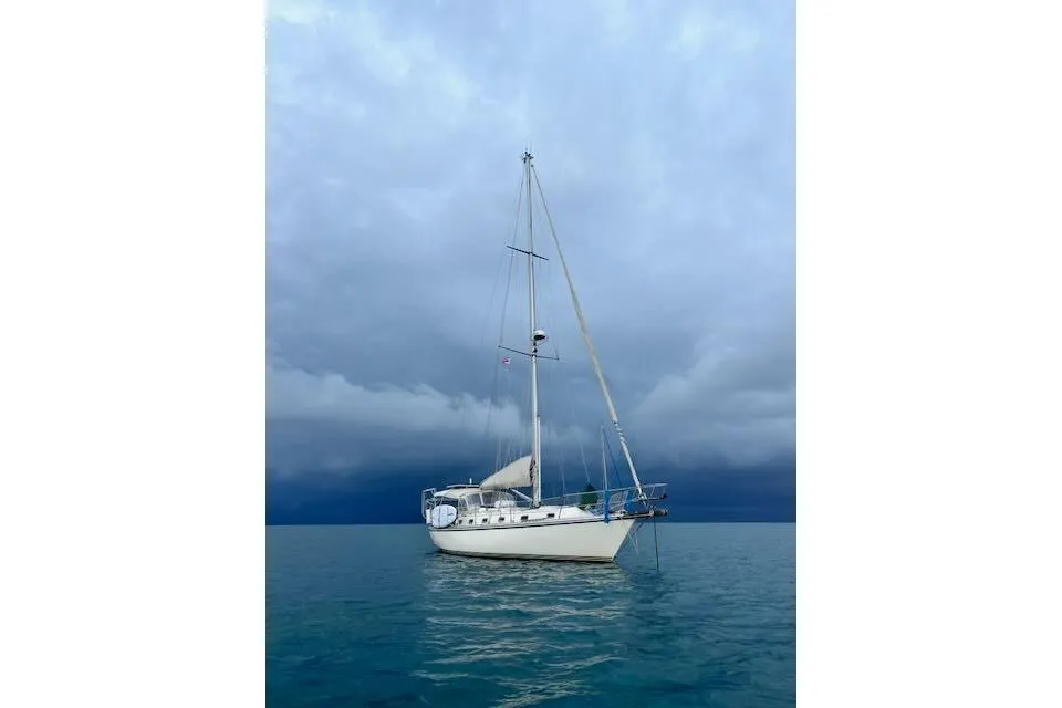 Sailboat Caliber 40LRC 2004 on calm water under cloudy sky.