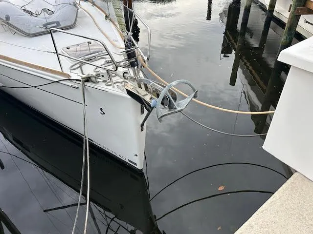  Yacht Photos Pics Beneteau Oceanis 45 sailboat docked, 2016 model, with visible anchor and calm water reflection.